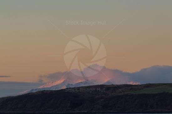 Beautiful sunrise just starting to light up the mountains of Arran, Scotland