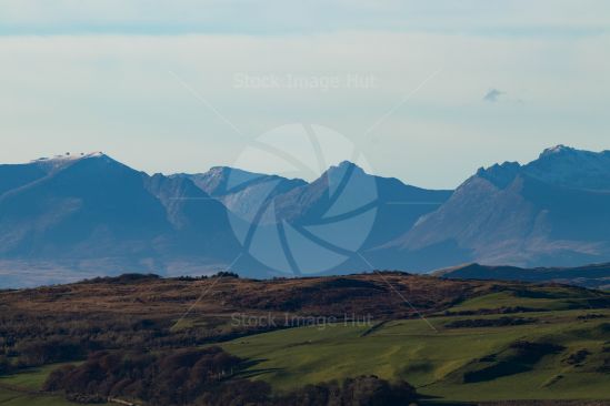 The distant mountains of Arran in Scotland starting to show the coming of winter