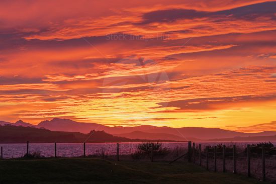 A sunning sunset over Arran, West coast of Scotland turning the sky red