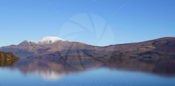Looking across loch lomond to a snow capped Ben Lomond mountain in the Scottish Highlands