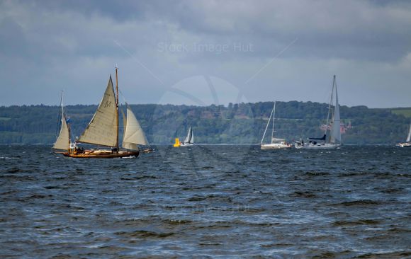 Yachts of all sizes racing through choppy sea during the Fife regatta, Largs 2022