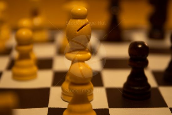 Close up shot of chess board pieces, focused on the white bishop