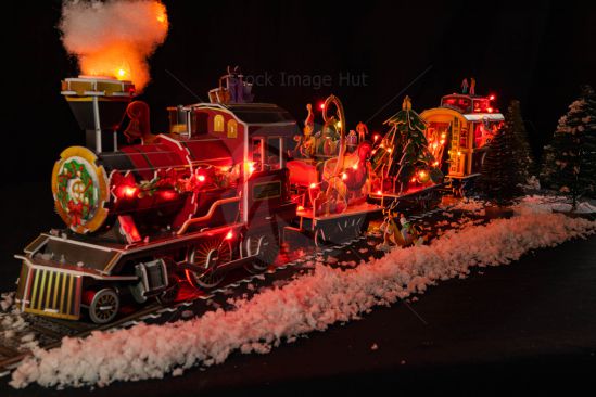 A 3D model of a Christmas train with fairy lights and decorations and fake snow