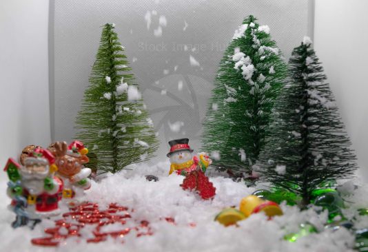 A mini Christmas Wonderland scene with snowman, Santa and falling snow
