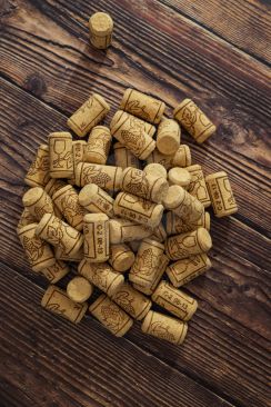 New wine corks grouped together on wooden table image