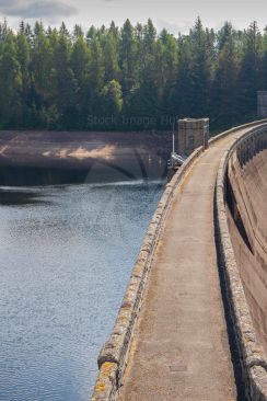 Looking down on top of large dam wall walkway image