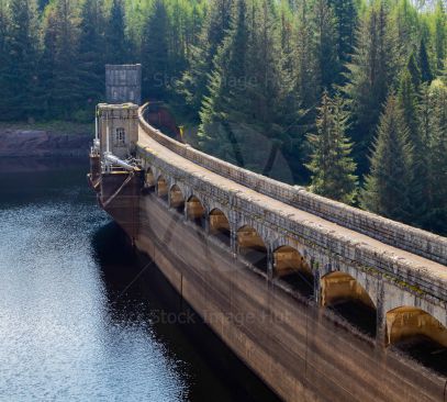 Dam wall curving round reservoir  in Scottish Highlands