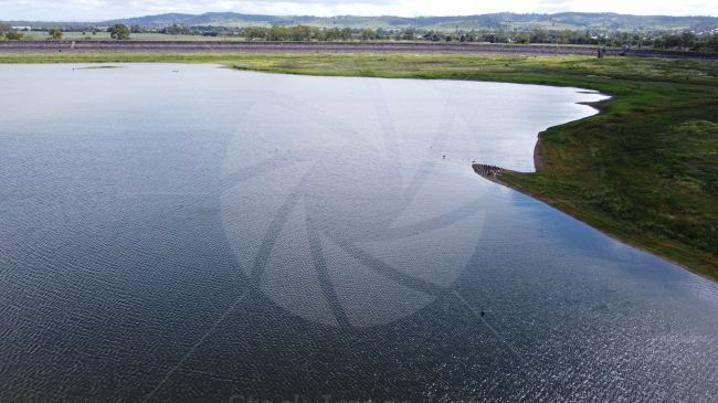 Drone shot of reservoir in Queensland Australia looking down on large birds
