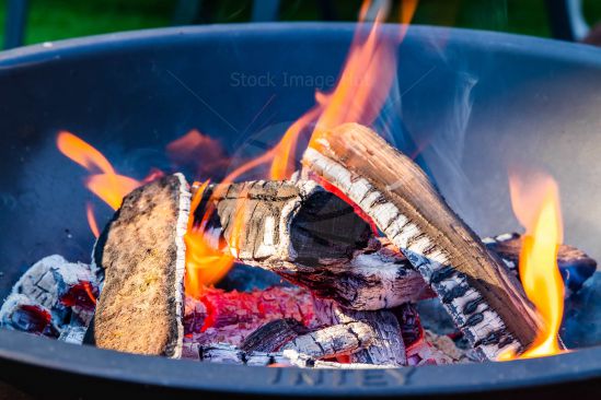 Firepit burning logs outdoors