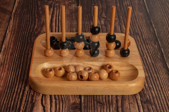 Popular four-in-a-row game made from wood and sitting on wooden background image