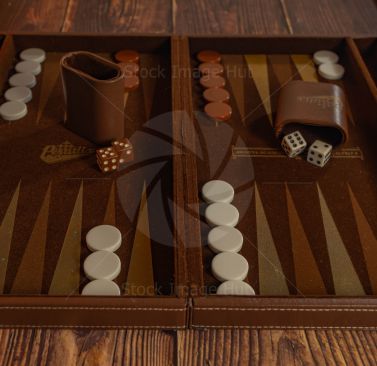 Backgammon board game with two brown dice and two white dice and white and brown counters image