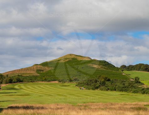 Two golfers out enjoying the sunshine and the stunning backdrop during their round of golf