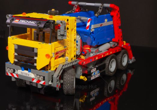 Toy Lego skip truck with bright yellow cab