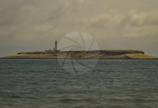 Working lighthouse sitting on island