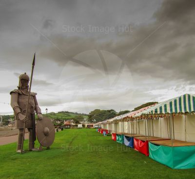 Festival stalls being erected ready for Vikingar festival as Magnus the Viking looks on