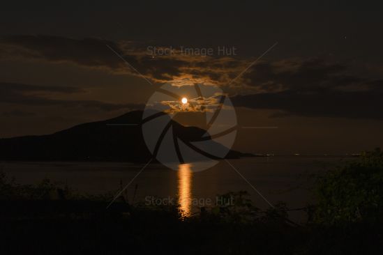Moon rising over the holy isle just off Arran, Scotland