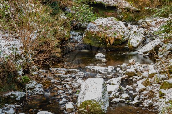 A small river with a light dusting of snow as winter starts to set in