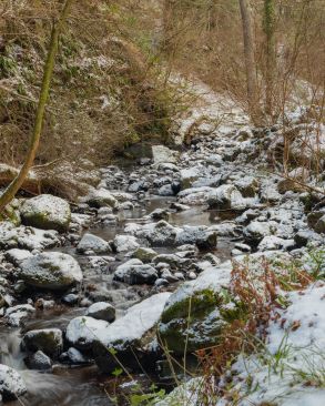 A little winding river with light dusting of snow
