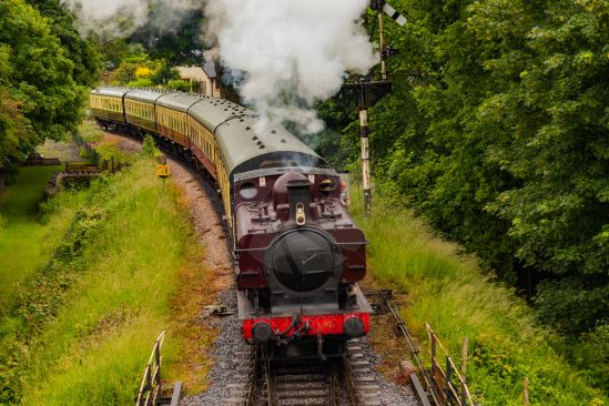 Classic old steam train approaching station