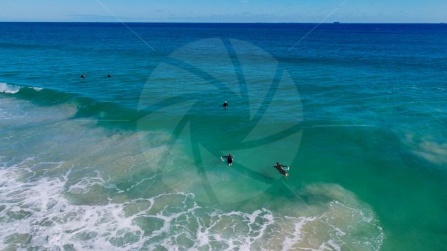 Surfers getting ready to catch the waves on a beautiful day at Scarborough beach WA