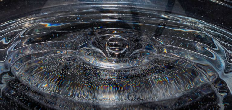 A water droplet hitting a pool of water
