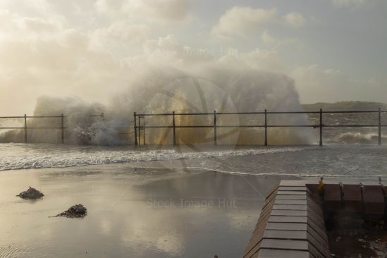 Huge waves crashing against seafront during storm