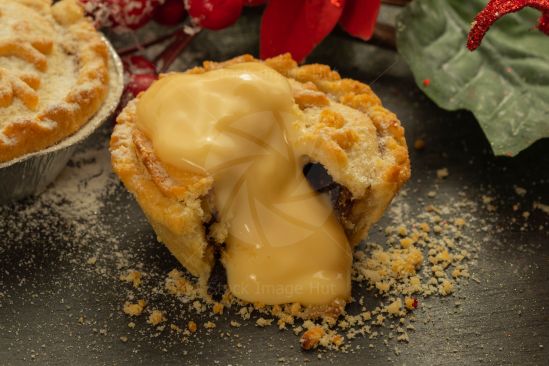 Delicious Christmas mince pies and custard with a beautiful Christmas background image